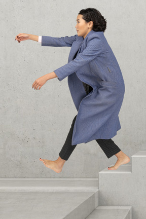 Woman jumping off the stairs