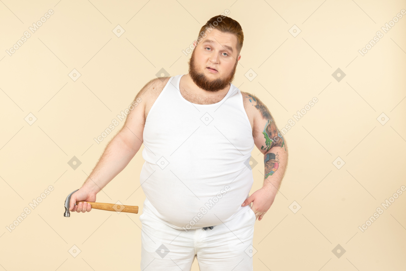 Emotional young big guy holding hammer