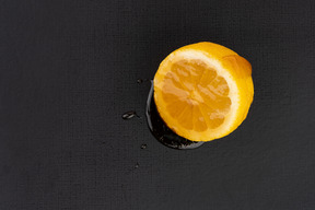 Marinated lemon on black background