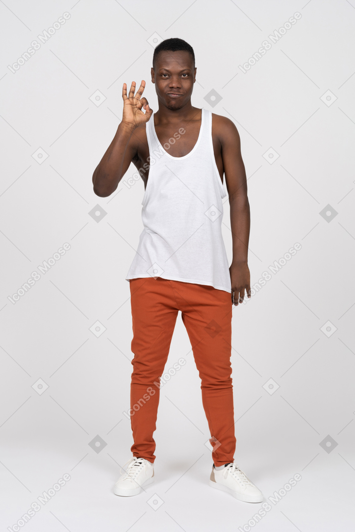 Front view of young man showing ok sign