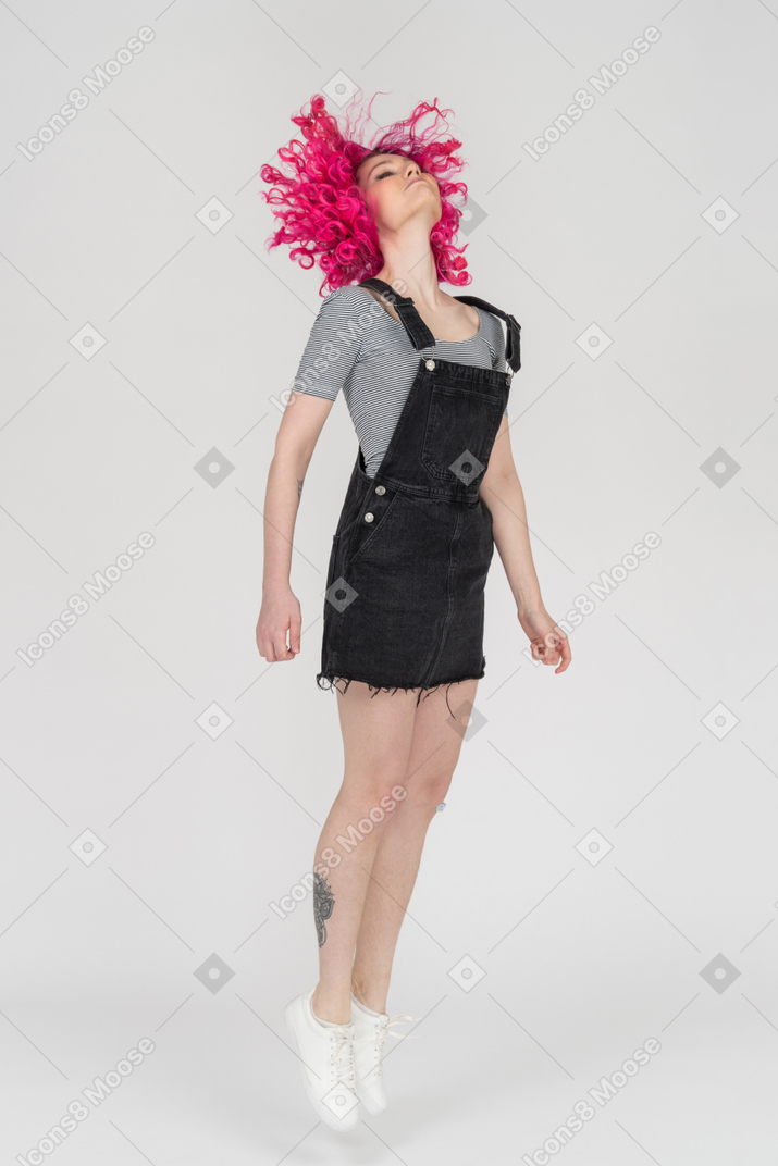 A pink haired girl jumping up