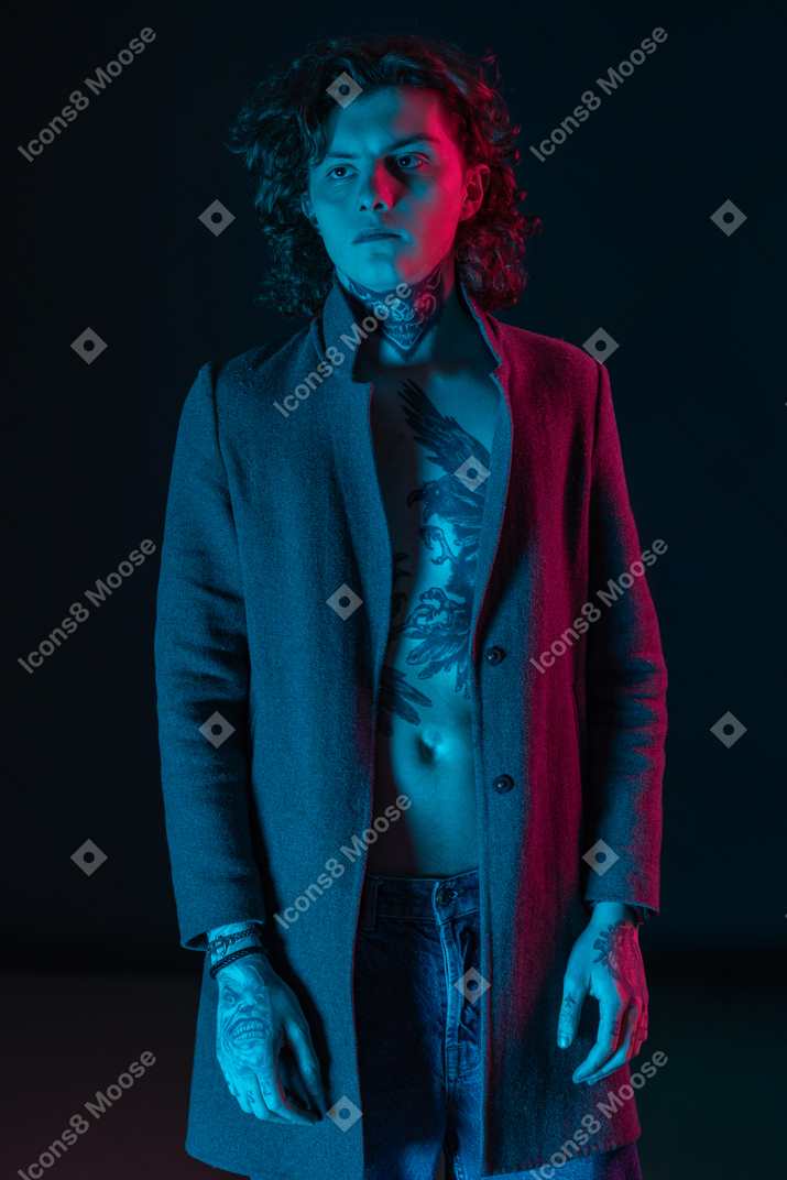 Male model standing straight in the dark