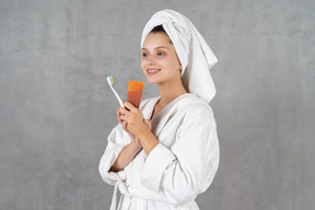 Smiling young woman ready to brush her teeth