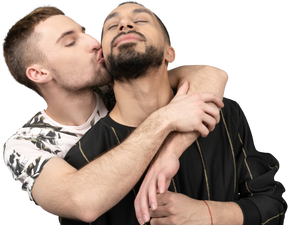 Close-up of a young caucasian man back hugging and kissing his partner