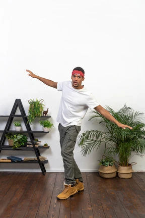 Good looking young man posing on the background of the apartment
