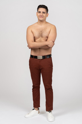 Front view of a shirtless latino man smiling