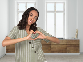 A woman making a heart shape with her hands