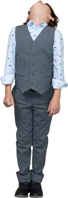 Front view of a boy in grey suit looking up