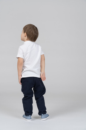 Back view of boy looking left