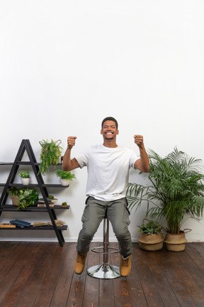 Good looking young man sitting on a chair