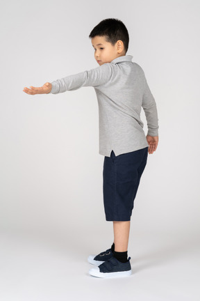 Boy stretching his hand forward