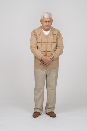 Front view of an old man in casual clothes standing still