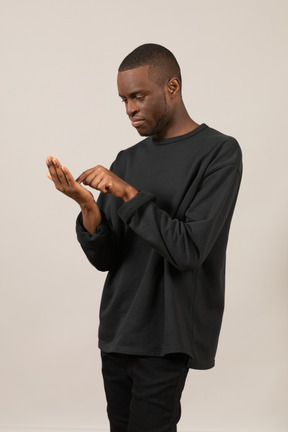 Hombre negro usando un teléfono inteligente imaginario