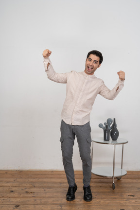 Happy man in shirt looking at camera