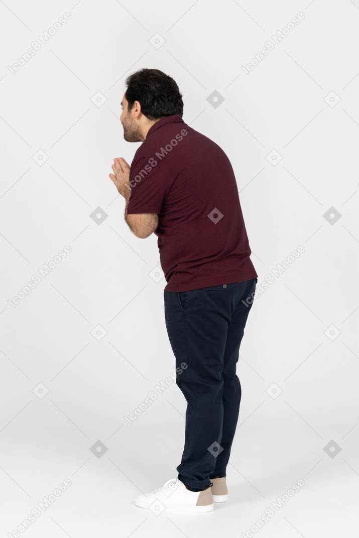 Back view of a man with folded hands