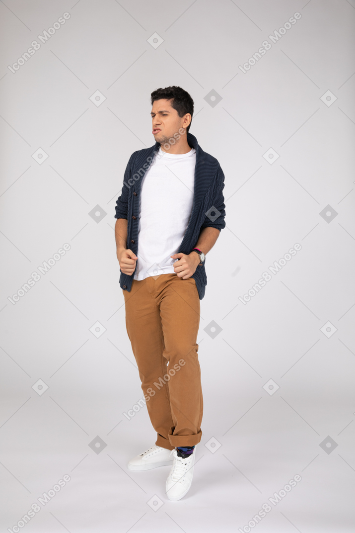 Confident man adjusting his cardigan