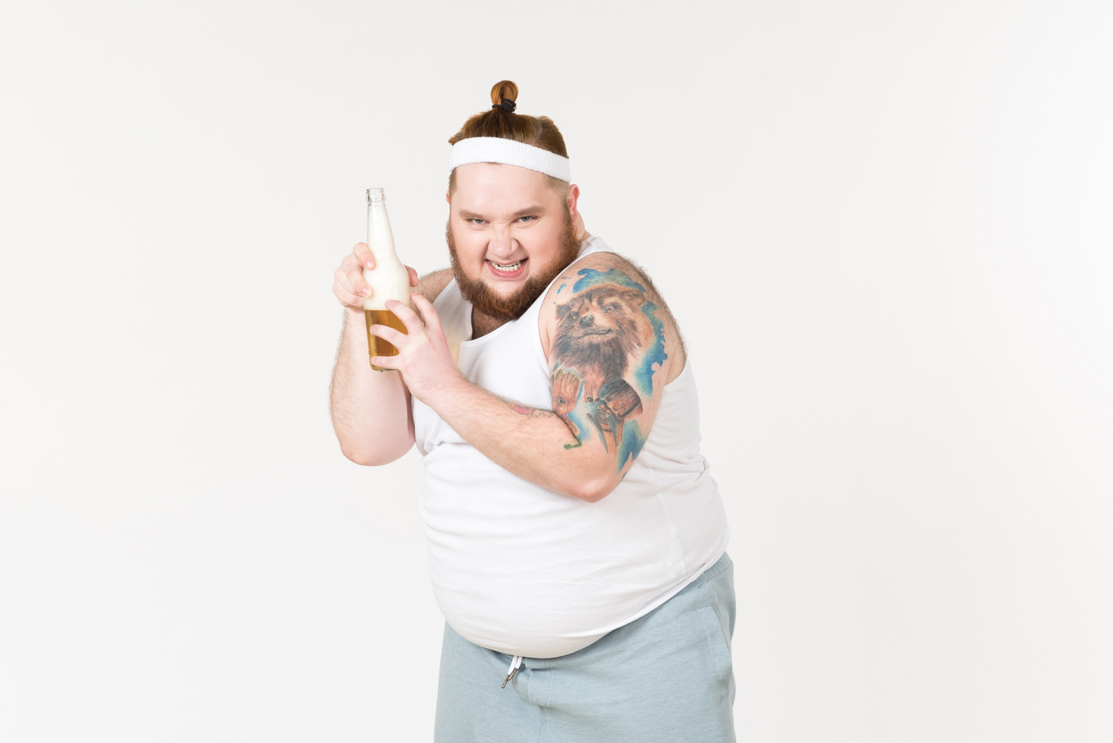 A fat man in sportswear holding a bottle of bear with evil grin