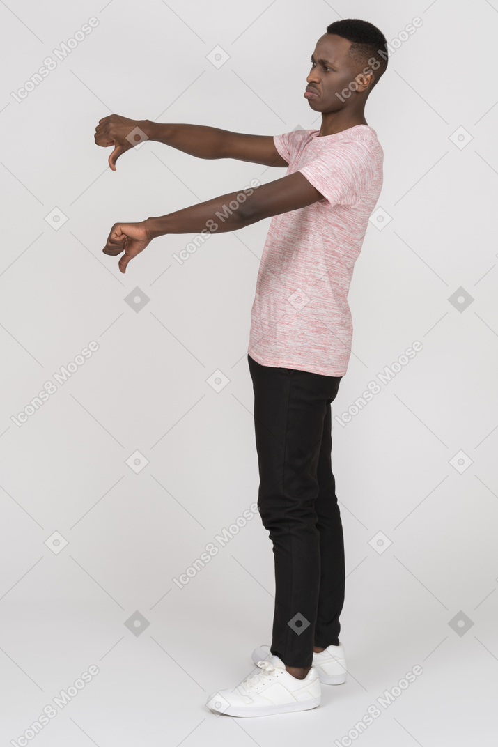Disgruntled man showing thumbs down with both hands