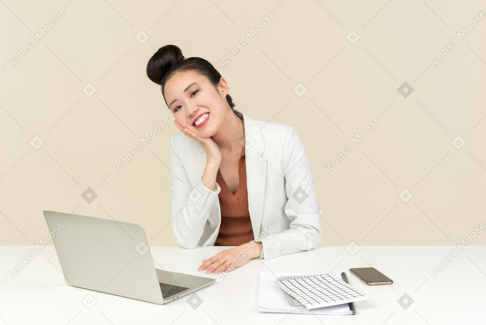 Smiling female asian office worker sitting at the desk