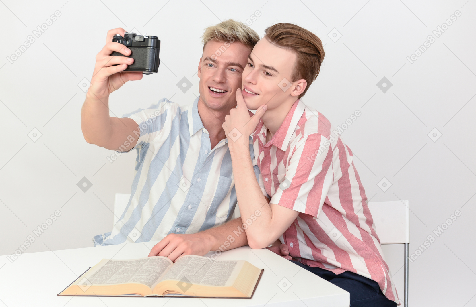 Gay couple taking a selfie with camera