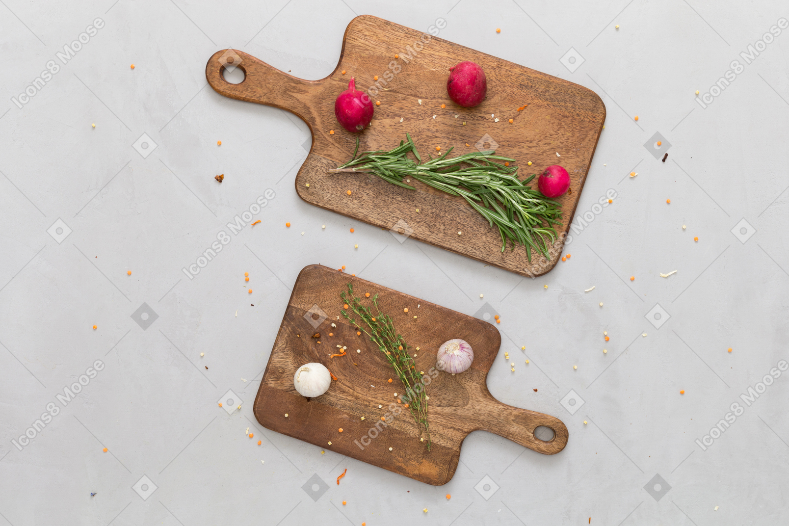 Red radishes, garlic and herbs served on wooden cutting boards