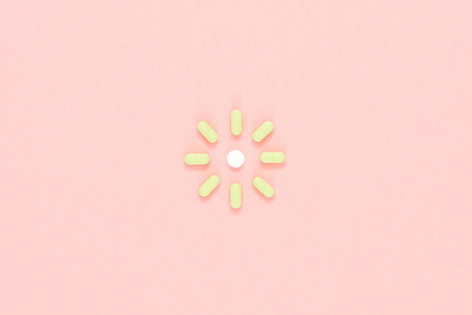 Green pills arranged in a shape of sun