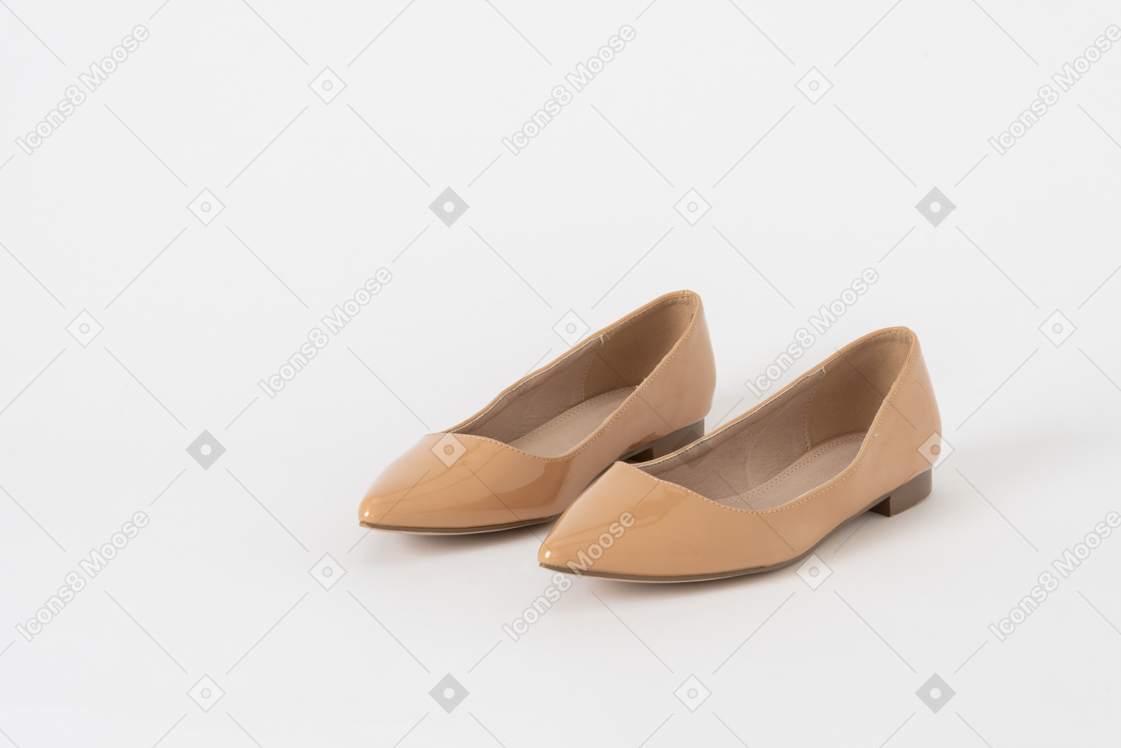 A three-quarter front shot of a pair of beige lacquer low heel shoes