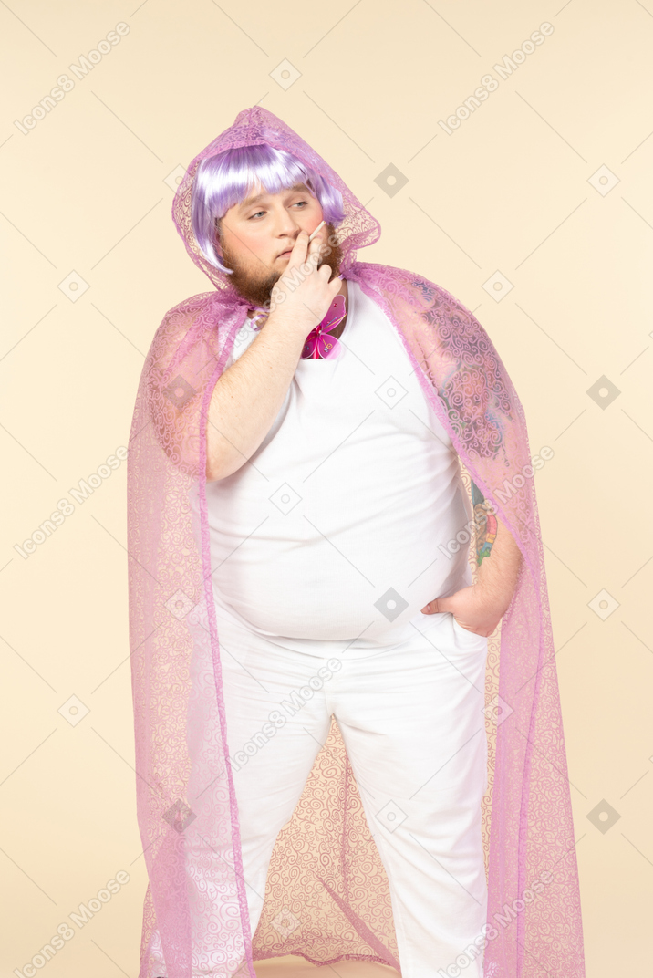 Young plump man in fairy cape smoking a cigarette with eyes closed