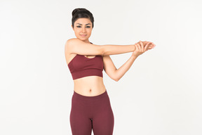 Indian woman in sportswear warming up