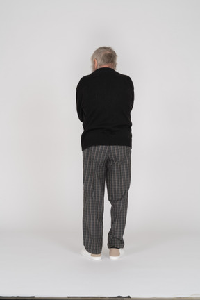 Rear view of a standing old man