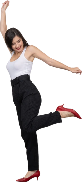 Side view of a happy young female in office clothing dancing and raising hand