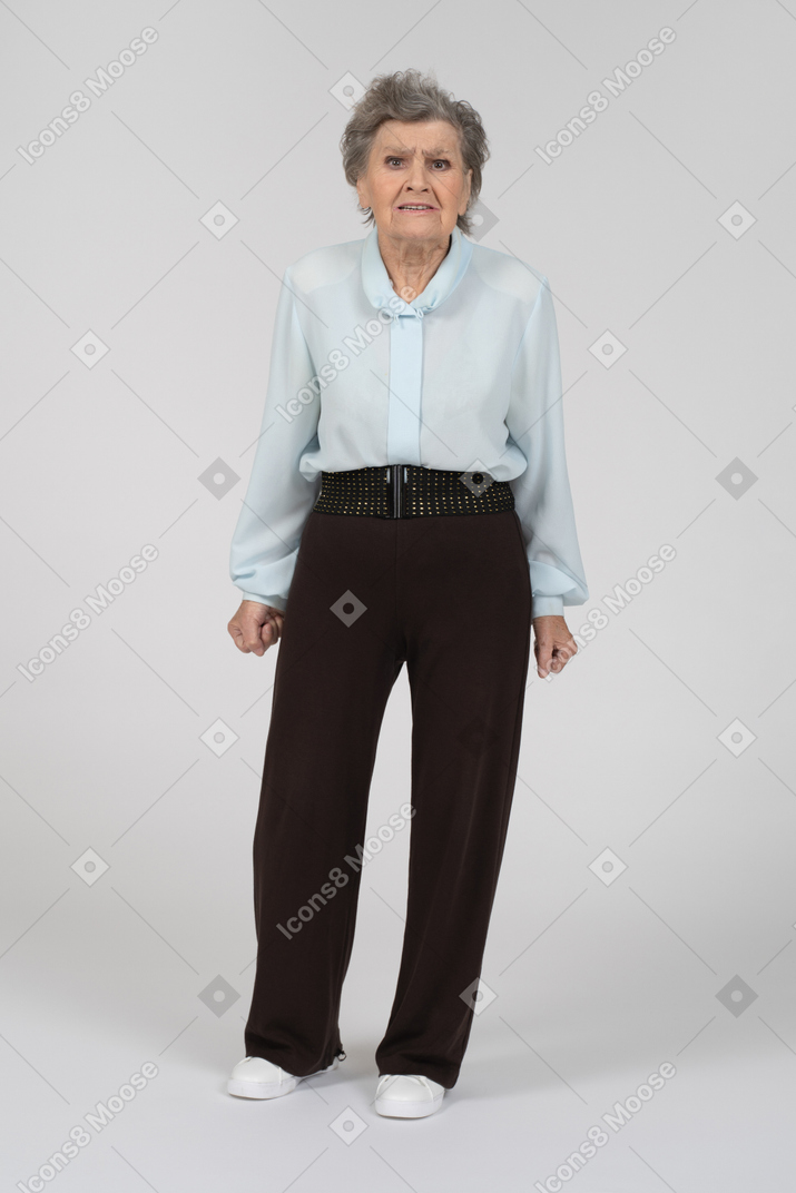 Front view of an old woman looking appalled