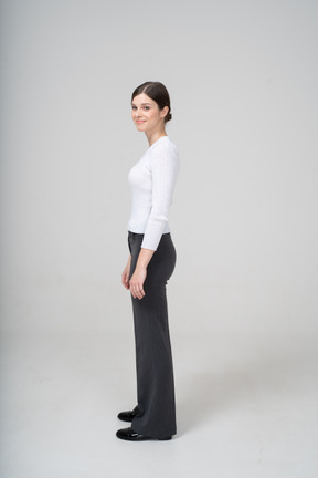 Side view of a smiling woman in business casual clothes