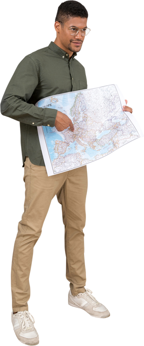 Three-quarter view of a man holding and pointing at a map