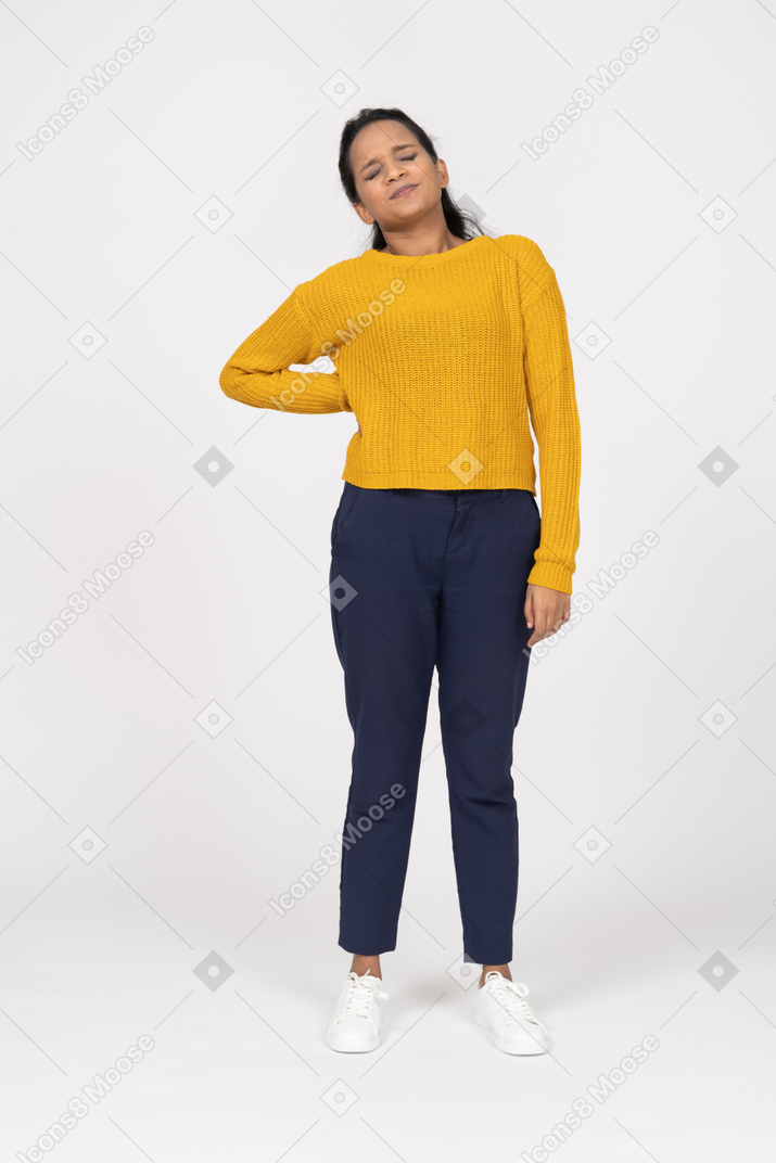 Front view of a girl in casual clothes suffering from pain in lower back