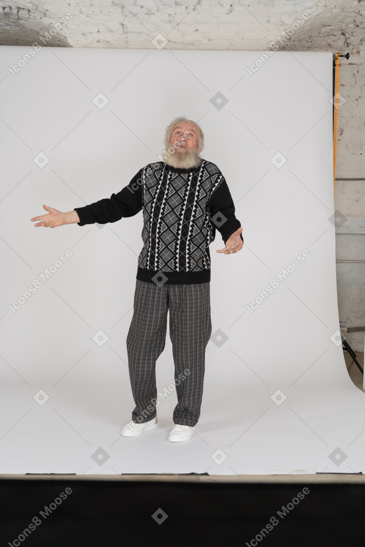 Old man looking up and spreading arms