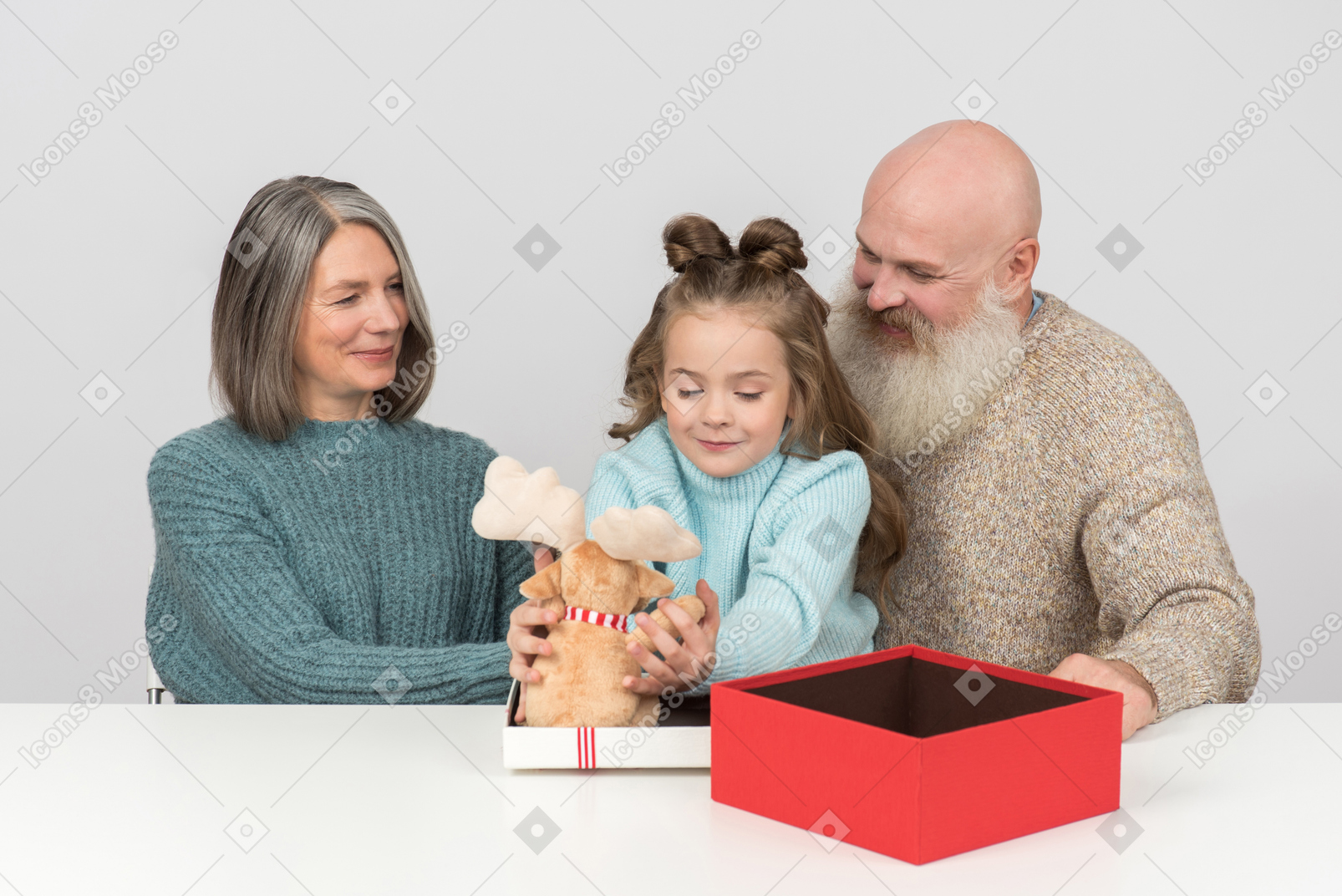 Grandparents looking as their granddaughter playing with toy