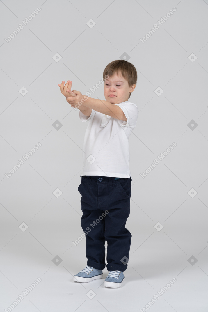 Little boy standing with outstretched arms