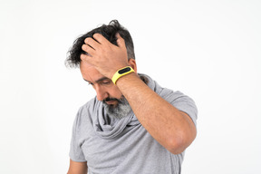 Mature man holding his head