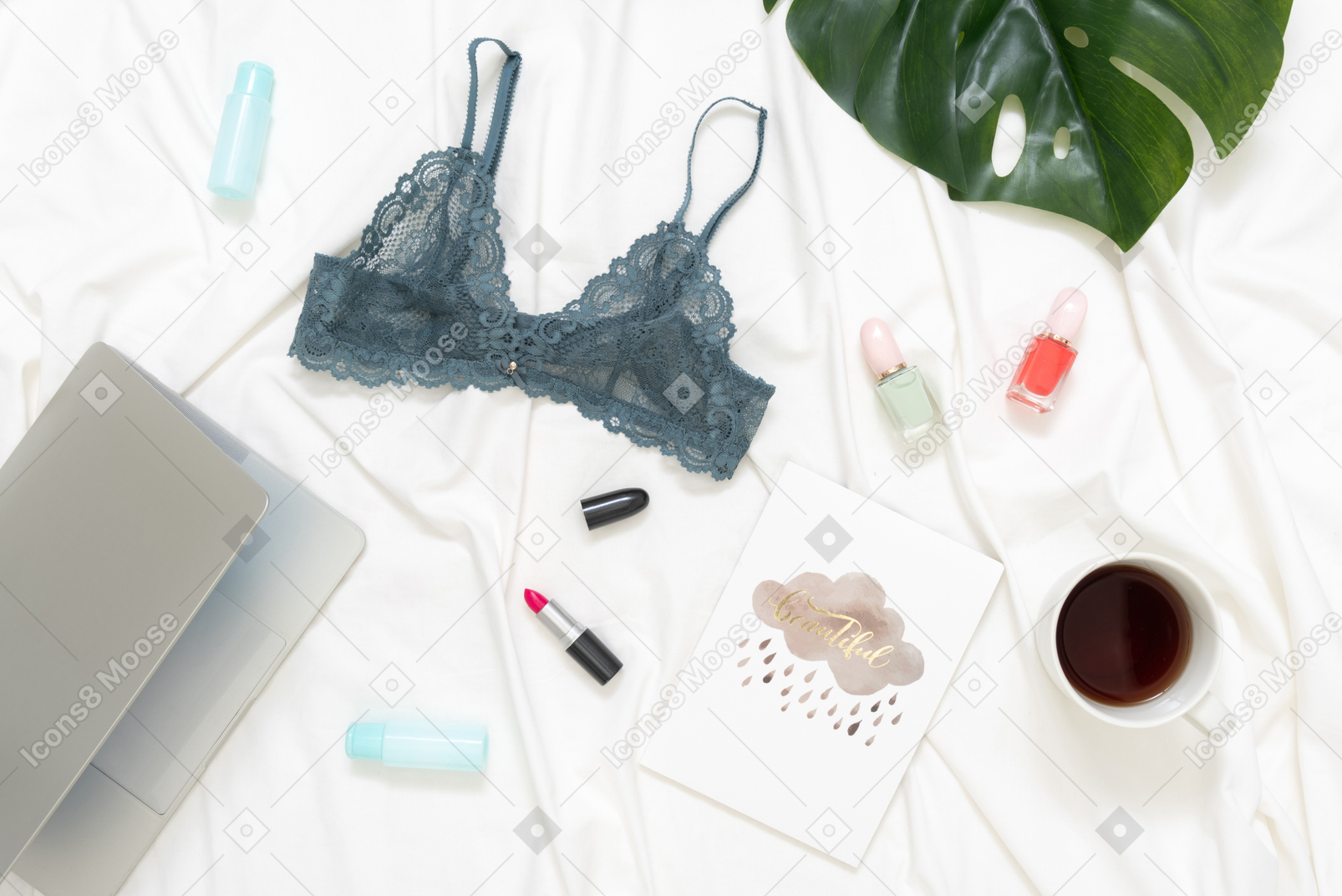 Blue lace lingerie, coffee cup and cosmetic bottles