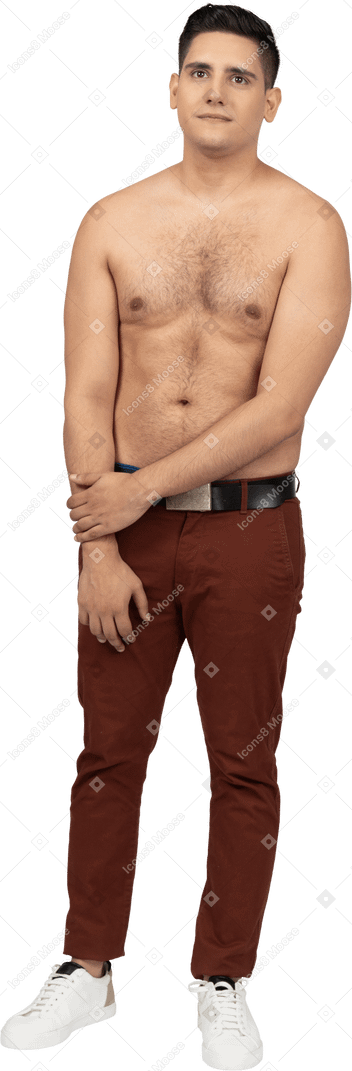 Front view of a shirtless latino man smiling uncertainly