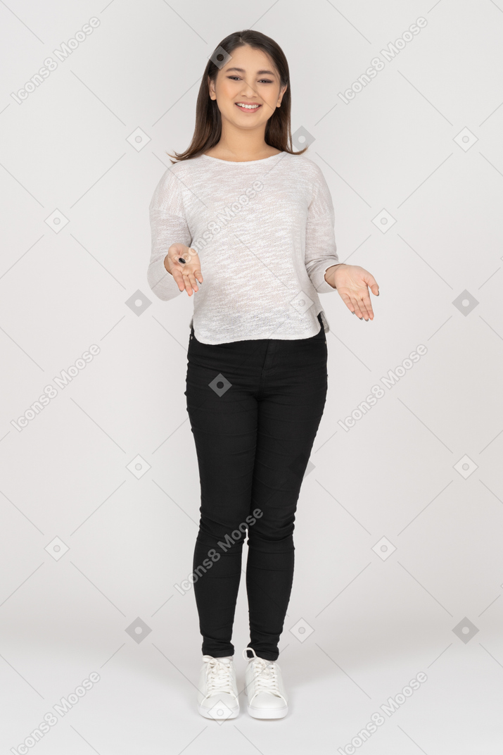 Front view of a smiling young indian female in casual clothes explaining something