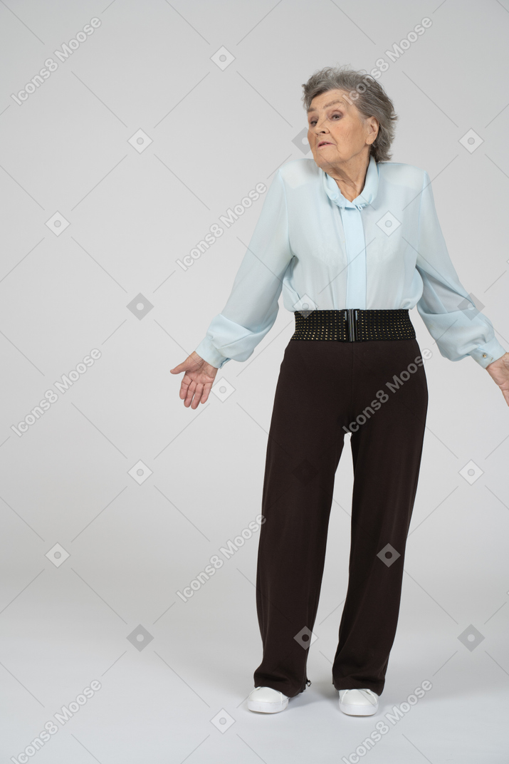 Front view of an old woman shrugging