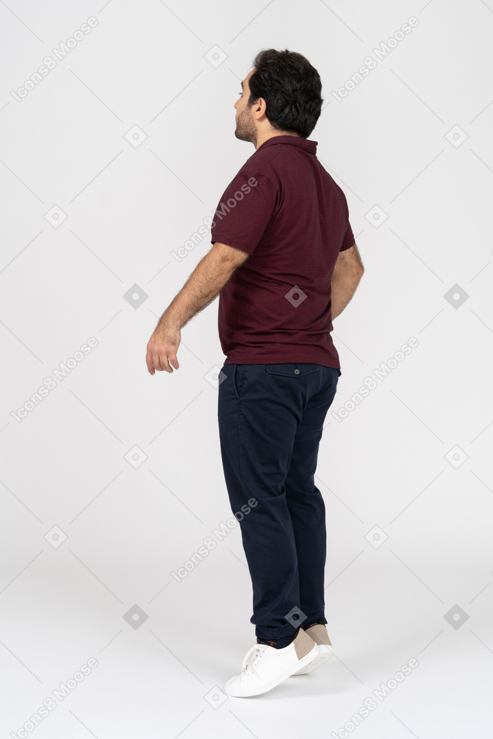Homem em roupas casuais em pé na ponta dos pés