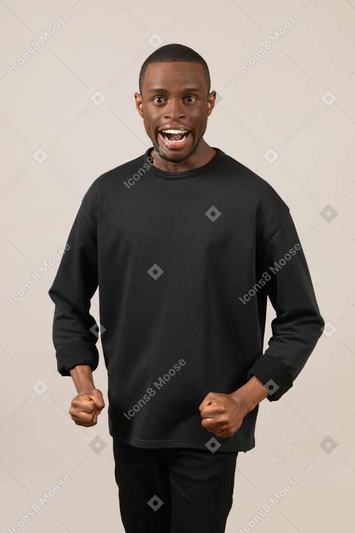 Man standing with clenched fists and open mouth