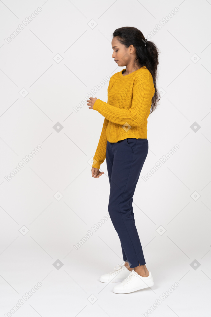 Side view of a girl in casual clothes looking down