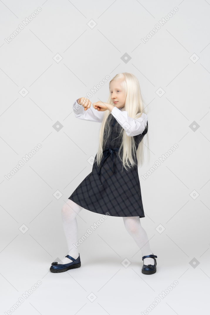 Schoolgirl doing a boxing stance