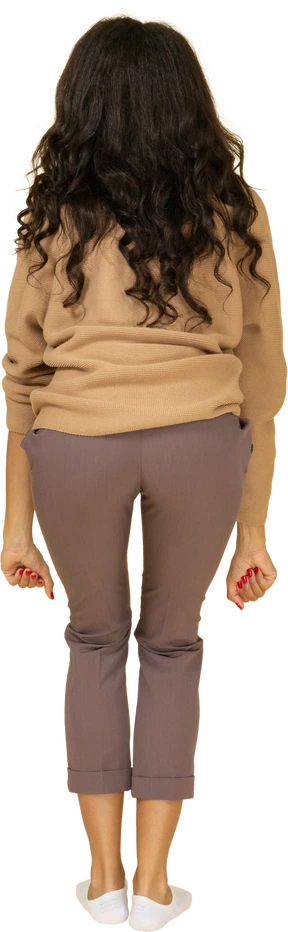 Back view of a dark-skinned young female lifting weights