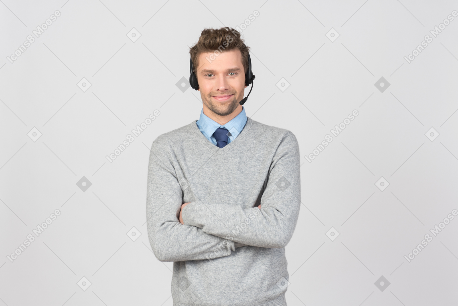Call center agent standing with his headset on and hands folded