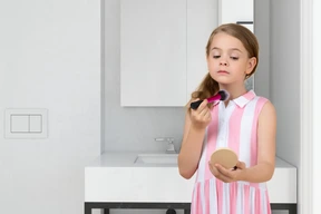 A young girl trying out makeup